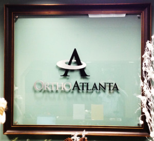 Interior dimensional letter sign for an office on glass mounted on stand-offs by Glass Graphics of Atlanta.