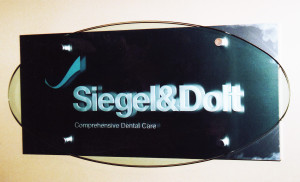 Business office sandblasted sign on stand-off mounting by Glass Graphics of Atlanta.