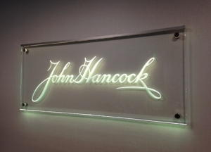 Carved glass office sign mounted on stand-offs by Glass Graphics of Atlanta.