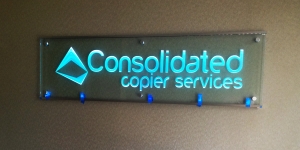Business office sandblasted sign on stand-off mounting and LED-lighted by Glass Graphics of Atlanta.