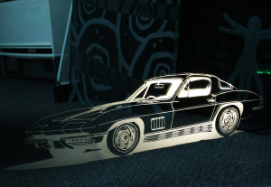 Lighted sandblasted image of a corvette in a glass panel by Glass Graphics of Atlanta.