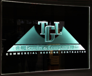 Carved commercial logo in glass panel with LED-illumination. All by Glass Graphics of Atlanta