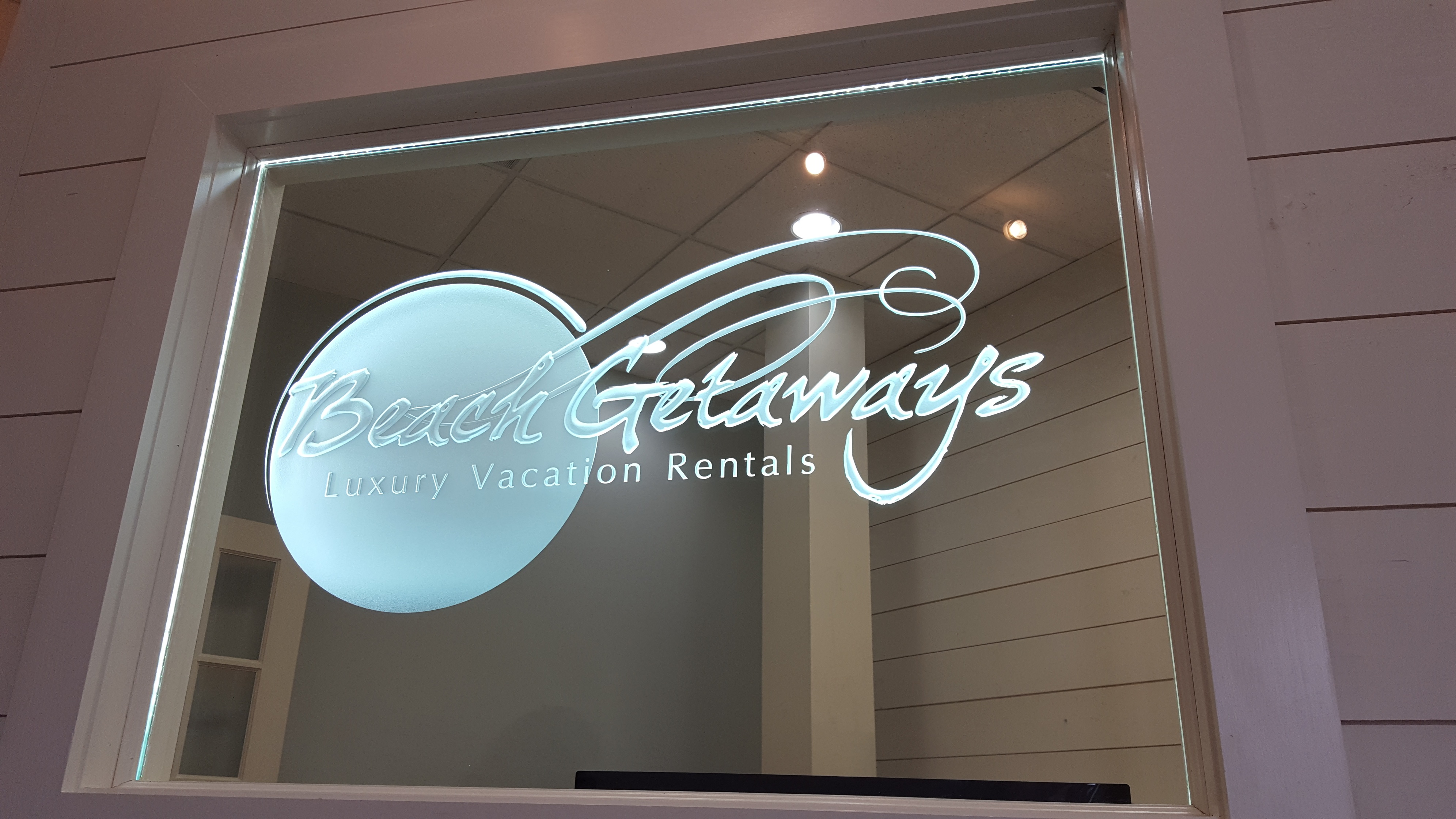 Beach Getaways  Luxury Vacation Rentals logo sandblasted on glass by Glass Graphics